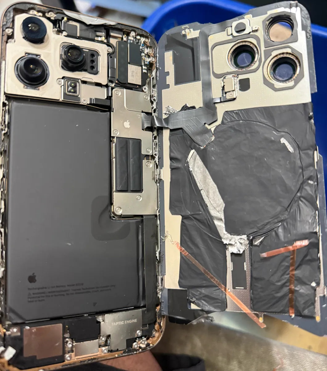 iPhone Pro opened at Franchitti's Fix showing messy tape and foil left by an earlier repair elsewhere, Hillcrest and University Heights