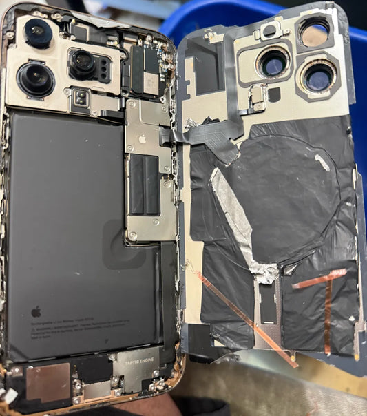 iPhone Pro opened at Franchitti's Fix showing messy tape and foil left by an earlier repair elsewhere, Hillcrest and University Heights